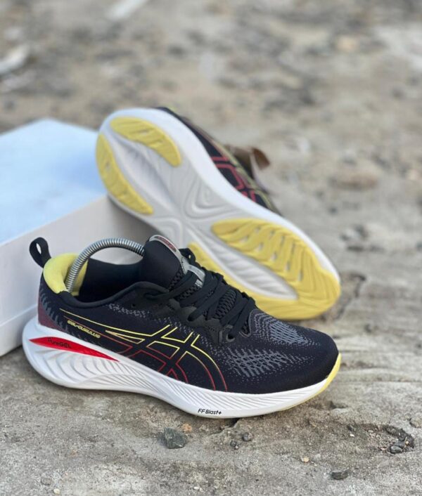 Black ASICS running shoes with a nice yellow and red outline.